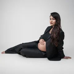Empowered, fearless, and expecting. This stunning solo maternity shot showcases the perfect blend of elegance and confidence in a modern power suit.