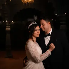 An intimate dance in a softly lit hall. We focus on the quiet moments of connection between the couple.