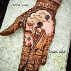 A classic Karwa Chauth design, featuring the traditional scene of a woman with a puja thali looking at the moon. I can incorporate names and other personal elements to make your festive mehndi unique.