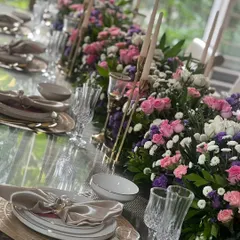 We transform spaces into elegant dining experiences. For this sit-down lunch, we created a stunning floral runner with tapered candles, setting a sophisticated and intimate tone for the guests.