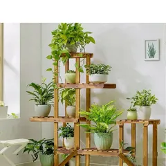 The bamboo planter stand is shown here fully styled with a variety of houseplants, demonstrating its capacity and sturdy construction.
