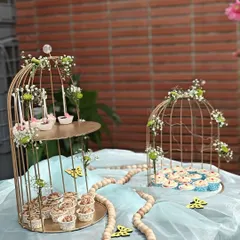 We bring the sweetness to your celebration with our elegant dessert table setups. This display, featuring a variety of our cupcakes and treats in decorative birdcages, was designed for a beautiful outdoor party.