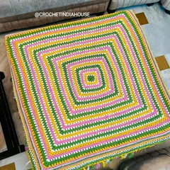 A top-down view of the multi-color crochet table mat, showing the clean, concentric square pattern. I can create this design in any size or color combination you need.