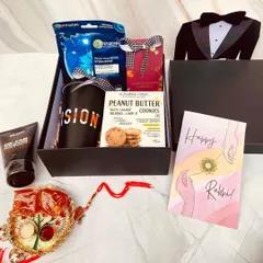 A dapper gift for a dapper brother. This Rakhi hamper comes in a tuxedo-themed box and is filled with men's grooming products, a mug, and cookies.