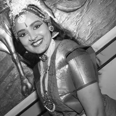 A timeless black and white portrait of the dancer, emphasizing her smile and expression. This artistic choice adds a classic, dramatic feel to the performance portfolio.