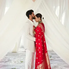 Sonakshi and Zaheer after their ceremony, standing under a simple, elegant canopy of white fabric. The floor, scattered with white petals, added to the pure and timeless feel of this magical union.