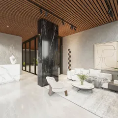 This lobby design uses a strong black marble pillar as a central focal point, dividing the space while maintaining an open feel. The combination of a white marble reception, a wood-slatted ceiling, and minimalist art creates a sophisticated and welcoming atmosphere.
