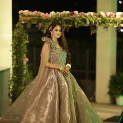 Posing for a portrait at her cocktail event. The lighting highlights the beautiful contour and the shimmer on her gown, creating a truly show-stopping look.