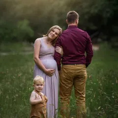 A family portrait that is also a maternity announcement. The way the little one looks on, with his parents expecting another, tells a story of a family on the cusp of a new chapter.