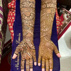 A complete view of a traditional Indian bridal mehendi. The design features different patterns on each arm, creating a unique and personalized look.