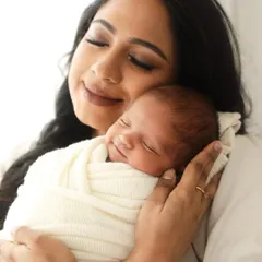 A mother's embrace, filled with peace and a gentle, sleepy smile from her baby. These are the quiet moments of pure love I aim to capture.