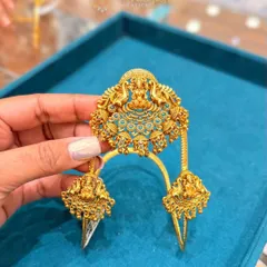 This is a beautiful South Indian bridal bajuband, also known as a vanki. This piece features a central Lakshmi motif with intricate detailing and is a perfect accessory to complete your temple jewellery look.
