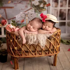 We added a tiny parasol and different hats to give the parents a variety of shots from their themed twin session. Every detail is planned to make the photos unique.