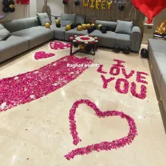 Another angle of the romantic birthday surprise. The floor is covered in rose petals forming a pathway and hearts, creating a truly memorable experience.