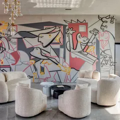 We were given a simple yet profound brief: "Picasso would be proud." Our response was this reimagining of his anti-war masterpiece, 'Guernica,' for a modern residential lounge. This hand-painted mural transforms a powerful historical statement into a personal, contemporary piece that anchors the room with its bold lines and emotional depth.