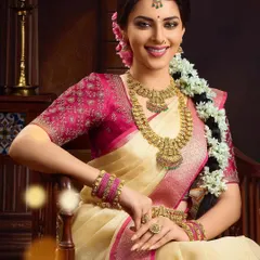 A seated portrait from the same South Indian bridal campaign, highlighting the intricate details of the hair, makeup, and layered necklaces. The complete look was designed to feel both traditional and radiant.