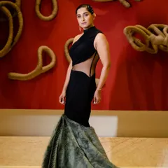 This is one of my more experimental designs. A black mermaid gown with an asymmetric sheer panel at the waist and a dramatic fur-detailed train, created for those who want a bold, high-fashion statement.