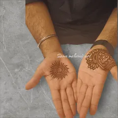 A simple yet powerful design for the groom, with a sun motif on one palm and initials on the other. A great choice for a minimalist look.