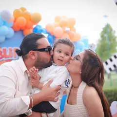 Kisses for the birthday boy! A beautiful family moment from a 2nd birthday party, full of love and affection.