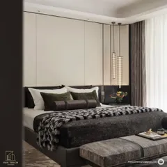 This view showcases the rich textures and layered bedding that contribute to the room's luxurious feel. The combination of a plush throw, varied cushions, and sleek pendant lighting creates a deeply inviting atmosphere.