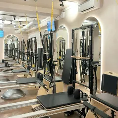 Our reformers are lined up and ready for your next class. The mirrored walls help you check your form and alignment as our instructors guide you through each movement.