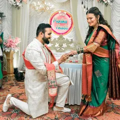The moment he gets down on one knee to propose during their engagement ceremony, surrounded by the smiles of their loved ones.