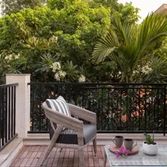 An all-weather wicker chair on a client's balcony. While I specialize in teak, I also source complementary pieces to complete indoor-outdoor spaces.