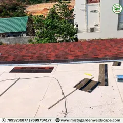 The shingles installation is nearly complete on this roof. The dual-tone red and black shingles create a modern, textured look that adds great curb appeal.
