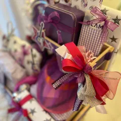 The vibrant purple and pink color scheme of the popstar hamper, with custom-wrapped gifts and musical note accents.