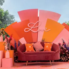 The main seating area for our 'Spectrum of Love' Haldi theme. This vibrant, multi-layered backdrop with a custom 'Love' cutout creates the perfect photo-worthy moment, capturing the joy and energy of the celebration.