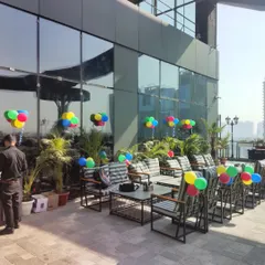 Simple, colorful balloon bunches placed strategically across this modern rooftop terrace add a festive touch without obstructing the view or walkways.