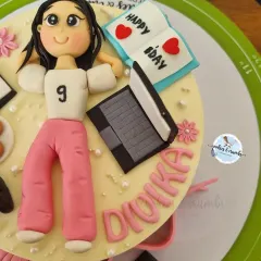 This cake is a perfect match for the birthday girl's hobbies. I created fondant versions of her laptop, headphones, cookies, and even a little book to capture her personality in edible form.