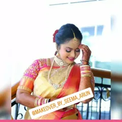 A candid shot capturing the serene beauty of a bride on her special day. The soft, glowing makeup highlights her features, while the traditional bun and jewelry complete this timeless South Indian muhurtham look.