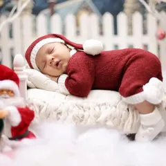 A close-up of our little Santa, sleeping soundly before his big night. The knitted red suit and hat add a cozy and adorable touch to the Christmas theme.
