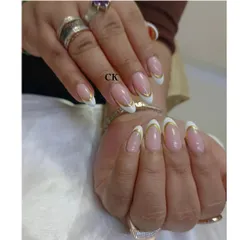 I love giving a modern twist to classic styles. This is an elegant French manicure on almond-shaped extensions, elevated with a sharp, clean line of gold chrome along the tip for a touch of luxury.