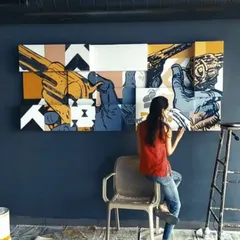 Here's a shot of us working on a multi-panel canvas installation for a lounge. This shows how we meticulously assemble large-scale wall art projects on-site.