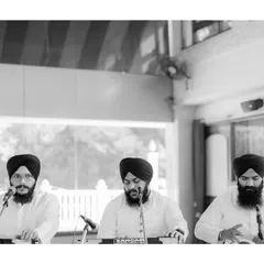 A black and white shot of the Ragis singing kirtan during the Anand Karaj. This image captures the solemn and spiritual atmosphere created by the musicians.