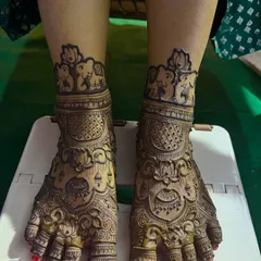 Full coverage bridal feet mehendi. This design is rich with traditional motifs, including lotuses and elephants, matching the bride's hand henna perfectly.