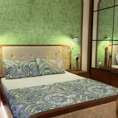 This master bedroom combines a pastel green accent wall with a beautiful cane and wood bed frame. The mirrored wardrobe doors enhance the sense of space, while the overall design creates a cozy and relaxing sanctuary.