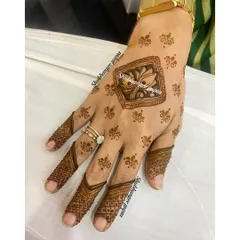 A very minimal and modern design. The central lotus motif is surrounded by tiny dots, and the fingers have simple, elegant patterns.