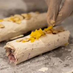 A chef carefully adds the final garnishes to our Mishti Malai rolls. This close-up shows the attention to detail and craftsmanship that goes into every dessert we serve.