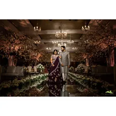 A couple walks down a reflective mirrored aisle, flanked by cherry blossom trees and elegant chandeliers. This setup creates a sophisticated and romantic ambiance, perfect for a grand entrance or a stunning photo opportunity.