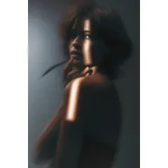 A soft, blurry portrait created during my Sigma lens review. I often play with focus and light to create emotion. This image, with its sliver of light on the model's face, is a perfect example of that experimental process.