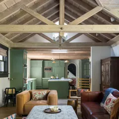 In this San Francisco home, we opened up the living area to the kitchen, creating a seamless flow for family life. The exposed wooden beams on the vaulted ceiling add rustic warmth, contrasting with the clean lines of the olive green kitchen cabinetry. It’s a space designed for connection, where cooking, conversation, and relaxation happen all at once.