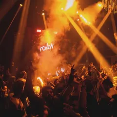 Golden light beams and thick smoke create a dramatic effect over the dance floor at SinQ Nightclub. The lighting is a key part of my performance.