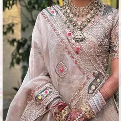 The final look. The deep color of the bridal mehendi beautifully complements the bride's stunning wedding lehenga and jewelry.
