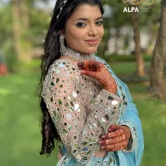 A portrait of the Sangeet look, showing the glowing skin, silver jewelry, and a hairstyle that is both intricate and elegant.