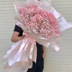 A breathtakingly large hand bouquet made entirely of pink baby's breath, also known as gypsophila. The sheer size and cloud like texture of this arrangement make it a real showstopper.