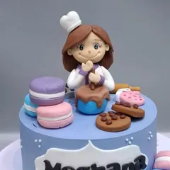 Another version of our popular baker-themed cake, this time in a lovely shade of blue. The fondant macarons and chocolate chip cookies add a delicious touch.
