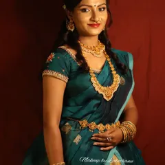 A full-length view of the model, showing how the makeup, hairstyle, and traditional half-saree come together. In my professional courses, we learn to style a complete look that is cohesive and photograph-ready.